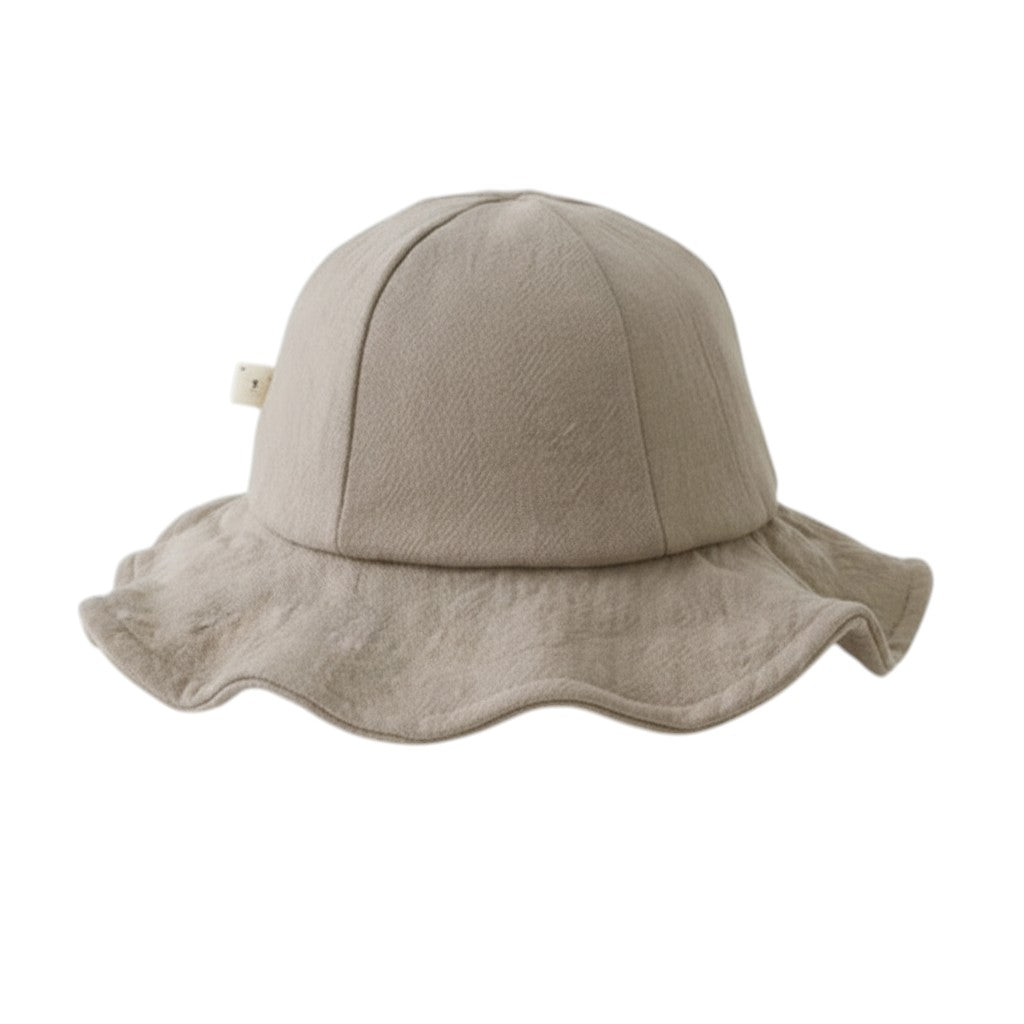 Peek Ah Boo beige linen wide brim baby sun hat with a decorative bow detail. Perfect for summer beach vacations.