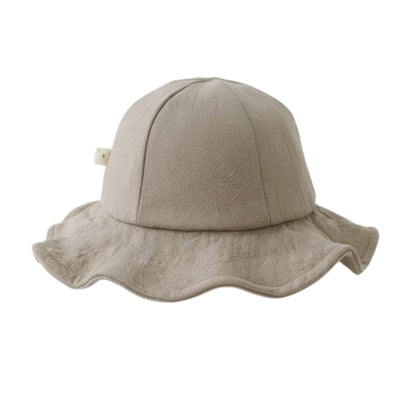 Peek Ah Boo beige linen wide brim baby sun hat with a decorative bow detail. Perfect for summer beach vacations.