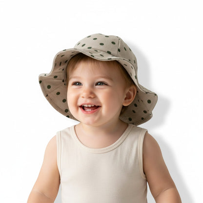 Peek Ah Boo beige baby sun hat with green polka dots and wide brim for UV protection.