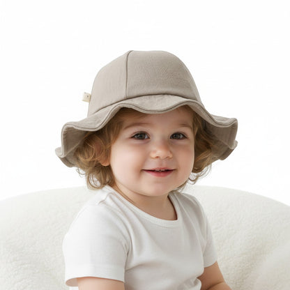 Peek Ah Boo beige linen-blend wide brim baby sun hat with a decorative bow detail and scalloped edge.