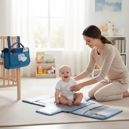 Peek Ah Boo blue waterproof diaper changing pad with built-in pillow and organizer pockets, unfolds to 21.5" x 22".