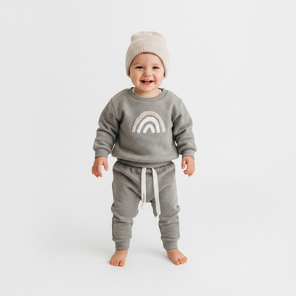 Peek Ah Boo grey ribbed cotton baby sweatshirt with rainbow appliqué and matching pants with drawstring.