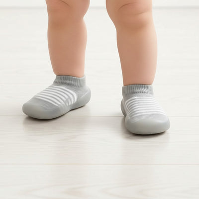 Peek Ah Boo grey and white striped knit baby shoes with non-slip rubber soles.