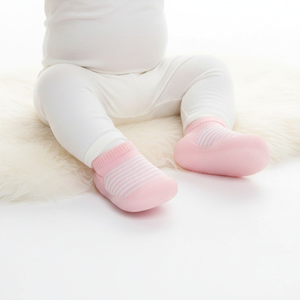 Peek Ah Boo pink and white striped knit baby shoes with non-slip rubber soles.
